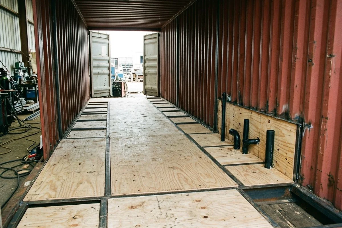Marine-grade subfloor with rough-in plumbing penetrations